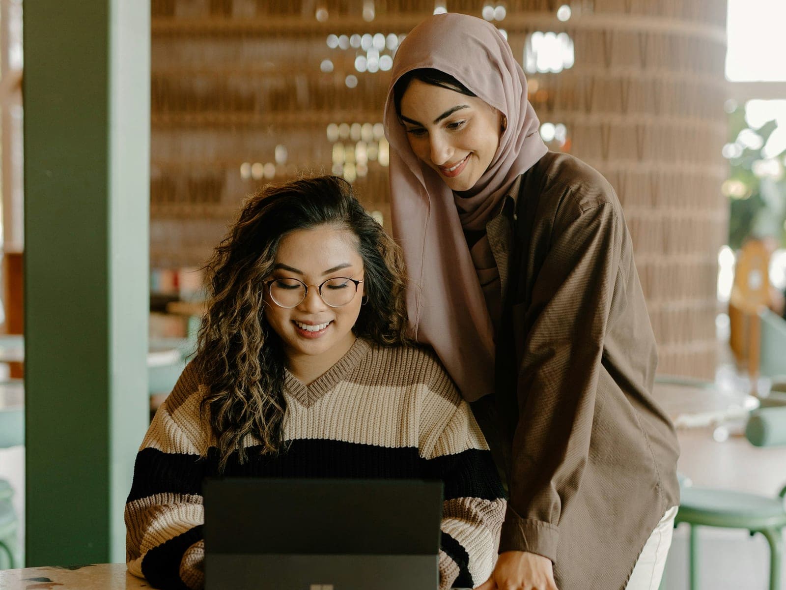 Two women looking at a laptop together